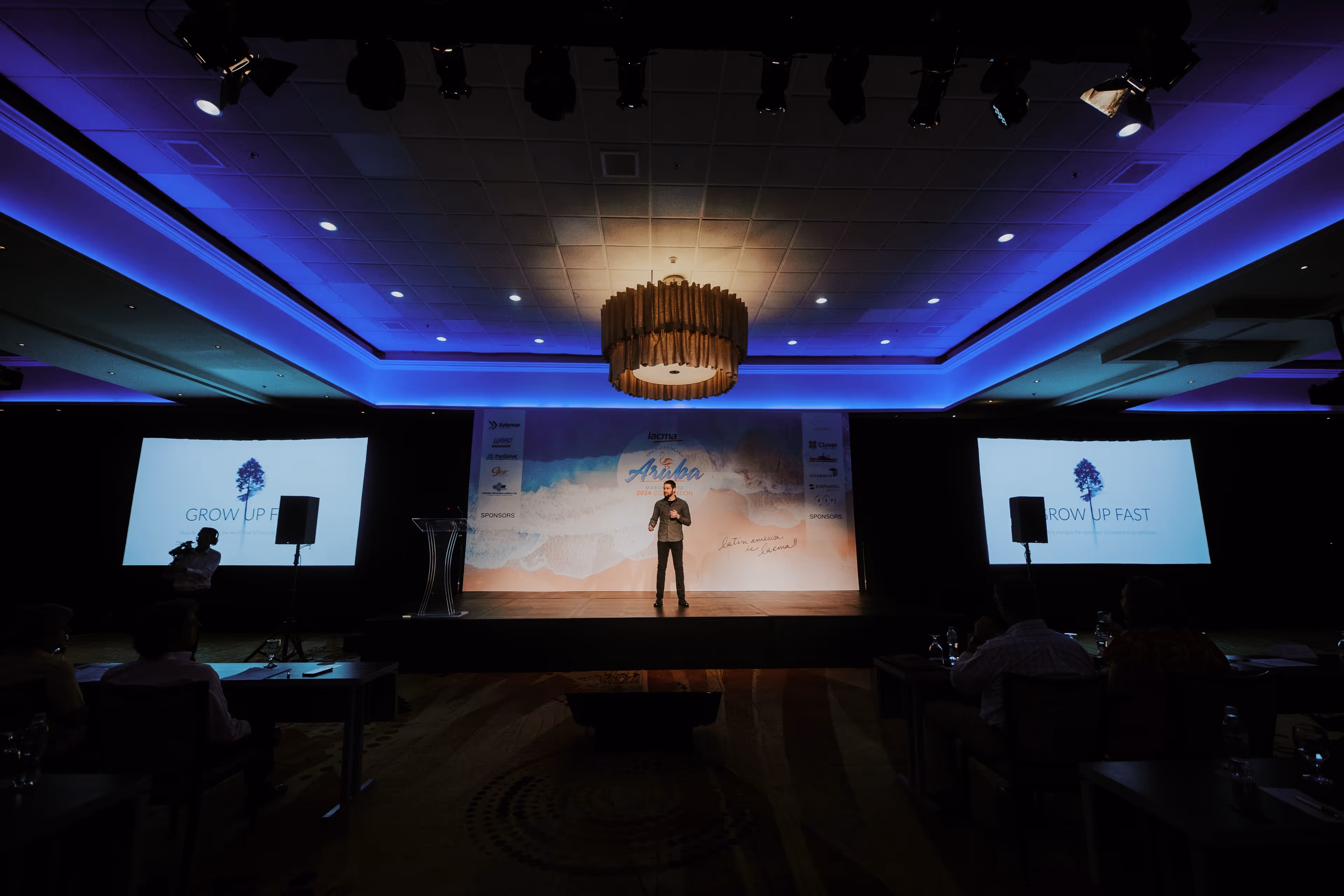 Zach giving a presentation about AI agents to a large audience of business leaders.